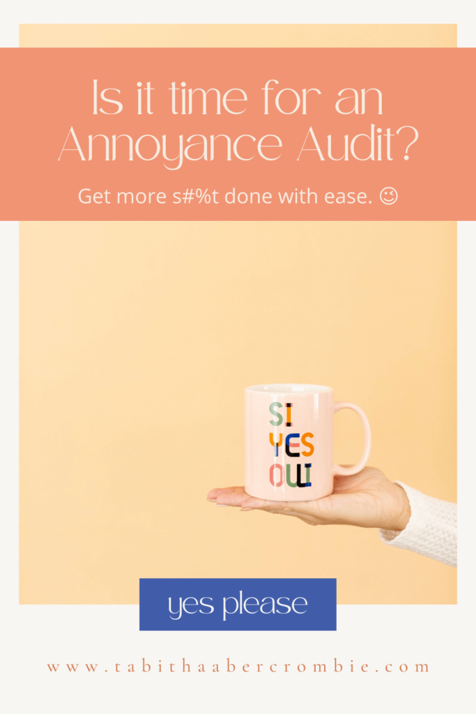 A hand holding a cute pink mug that reads, "Si, Yes, Oui," in answer to LA Clarity Coach Tabitha Abercrombie's questions: Is it time for an Annoyance Audit?